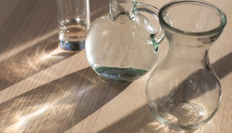 set of glassware on wooden table in daylight